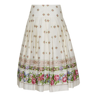 Sattelrock Blumenhoamat in Creme mit klassischem Bordürendruck und Blumenmuster am Saum.